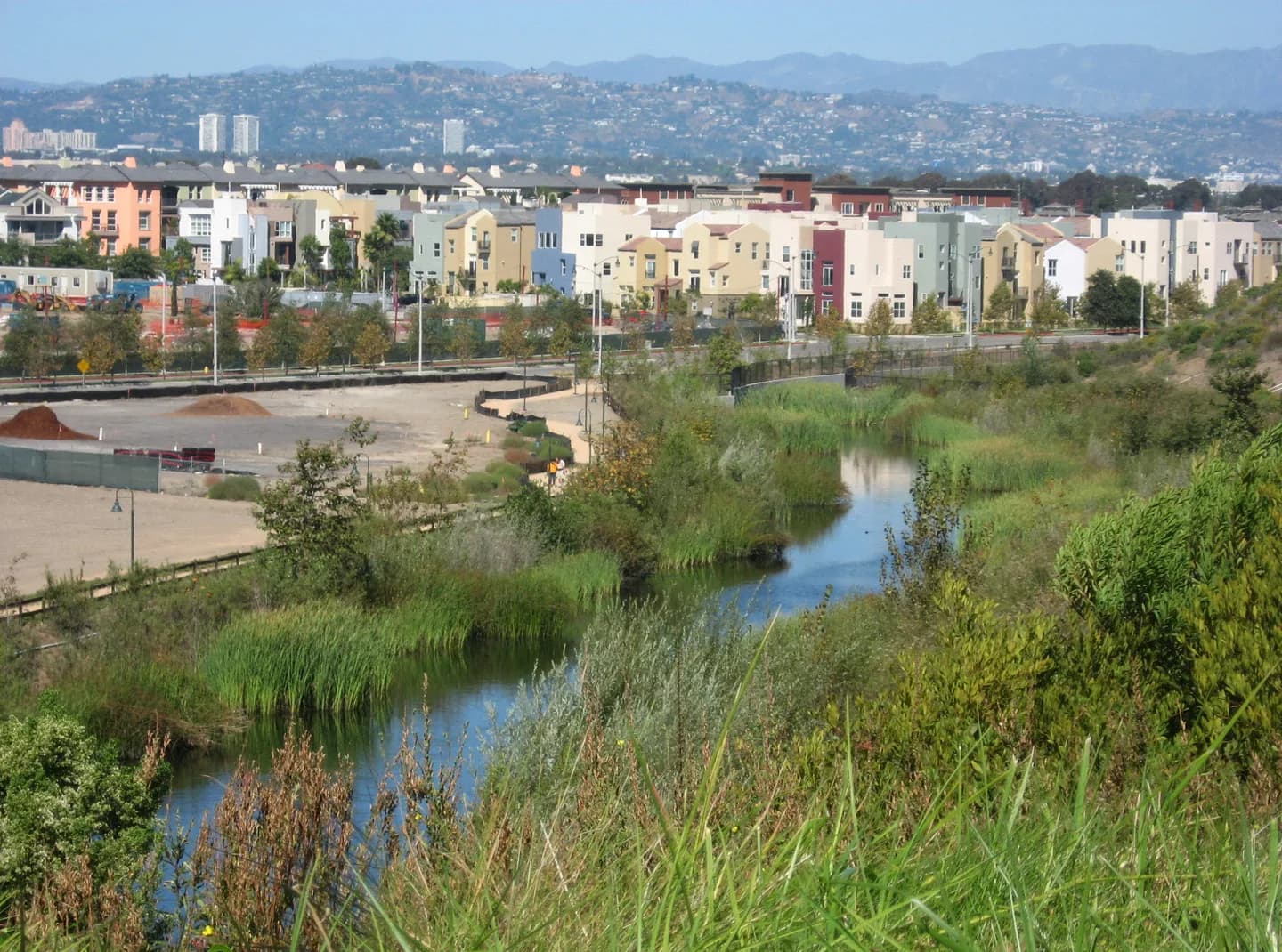 Bluff Creek and the new Playa Vista residential development on the Ballona wetlands, in Los Angeles, California. The Hollywood Hills, and behind them, the Verdugo Mountains, are seen in the distance. Camera location33° 58′ 06.34″ N, 118°